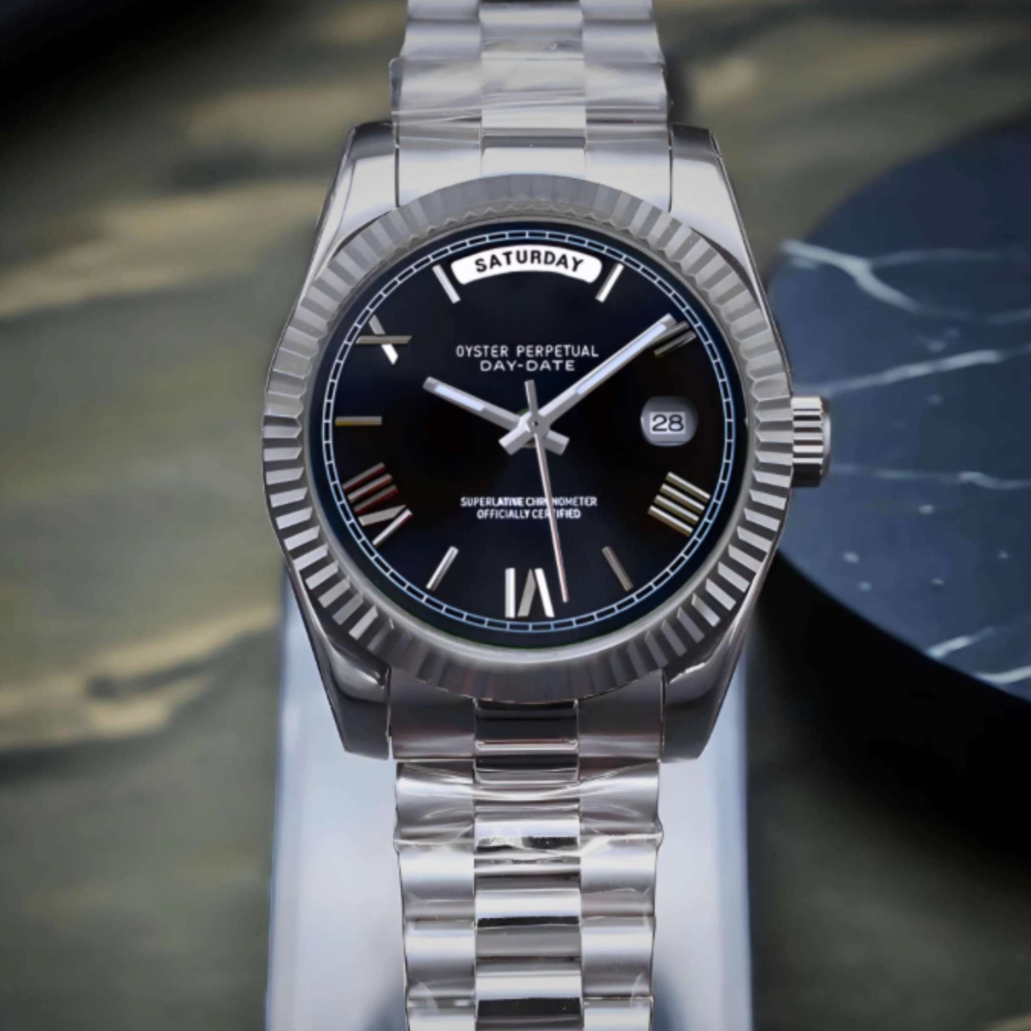 “Montre SEIKMOD Daydate Chiffres Romains Noir équipée du mouvement automatique CITIZEN Miyota 8285, cadran noir et boîtier acier poli, assemblée à la main en France”